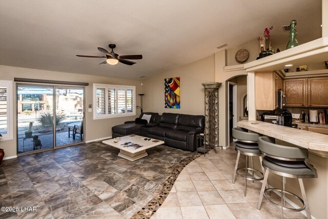 2641 Palo Verde Blvd N, Lake Havasu City, AZ 86404 - living area with lofted ceiling, ceiling fan, arched walkways, and baseboards