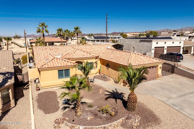 2641 Palo Verde Blvd N, Lake Havasu City, AZ 86404 - view of front of house with a garage, a tiled roof, concrete driveway, a residential view, and stucco siding