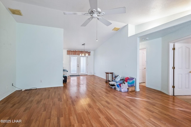 2974 Caravelle Dr, Lake Havasu City, AZ 86406 - unfurnished living room with lofted ceiling, light wood-style flooring, ceiling fan, baseboards, and a chandelier