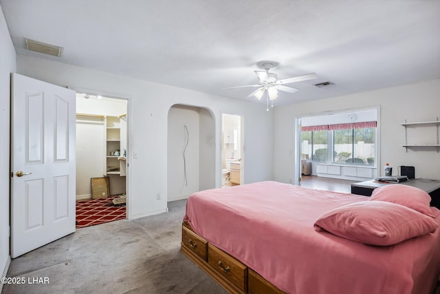 2974 Caravelle Dr, Lake Havasu City, AZ 86406 - carpeted bedroom with arched walkways, a walk in closet, ensuite bathroom, and a ceiling fan