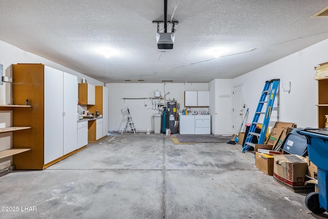 2974 Caravelle Dr, Lake Havasu City, AZ 86406 - garage with washing machine and clothes dryer, electric water heater, and a garage door opener