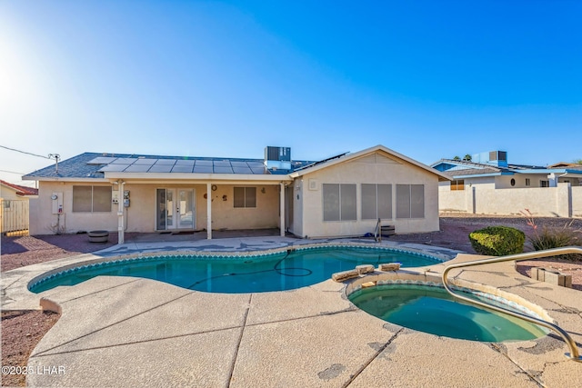 2974 Caravelle Dr, Lake Havasu City, AZ 86406 - view of swimming pool with french doors, an in-ground hot tub, a patio area, a fenced backyard, and central air condition unit
