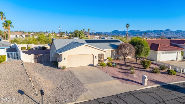 2974 Caravelle Dr, Lake Havasu City, AZ 86406 - ranch-style house with an attached garage, a mountain view, driveway, and a gate