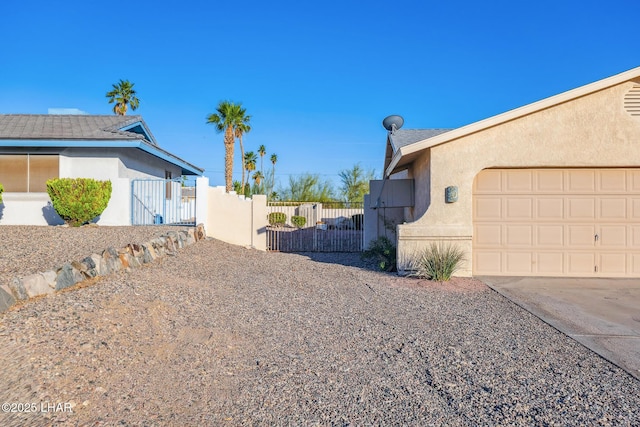 2974 Caravelle Dr, Lake Havasu City, AZ 86406 - view of property exterior featuring a gate, stucco siding, concrete driveway, and an attached garage
