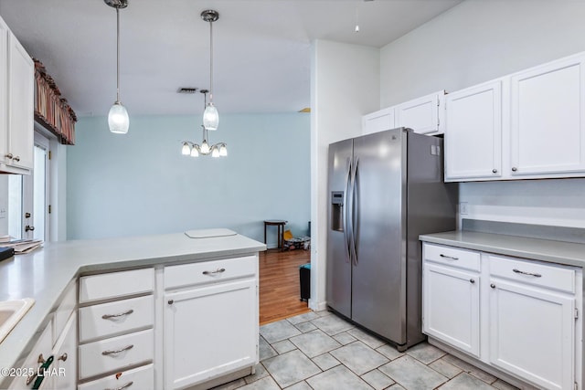 2974 Caravelle Dr, Lake Havasu City, AZ 86406 - kitchen with stainless steel refrigerator with ice dispenser, white cabinets, light countertops, and a peninsula