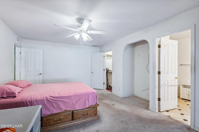 2974 Caravelle Dr, Lake Havasu City, AZ 86406 - bedroom featuring light carpet, arched walkways, ceiling fan, and baseboards