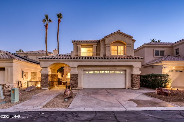 1351 London Bridge Rd Unit 2, Lake Havasu City, AZ 86404 - mediterranean / spanish-style house with a garage, stucco siding, driveway, and stone siding