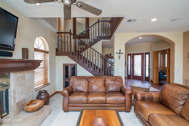 1351 London Bridge Rd Unit 2, Lake Havasu City, AZ 86404 - living room featuring ceiling fan, arched walkways, stairs, a wealth of natural light, and visible vents