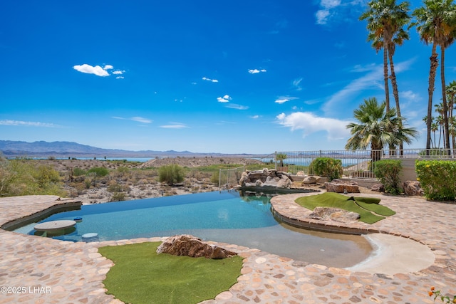 1351 London Bridge Rd Unit 2, Lake Havasu City, AZ 86404 - view of swimming pool featuring an infinity pool, a mountain view, and fence