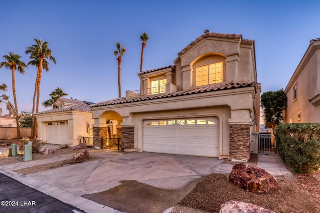 1351 London Bridge Rd Unit 2, Lake Havasu City, AZ 86404 - mediterranean / spanish-style home with driveway, a gate, a balcony, stone siding, and stucco siding