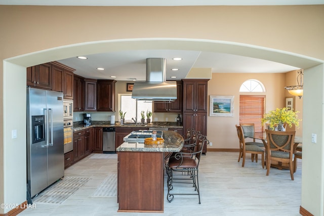 1351 London Bridge Rd Unit 2, Lake Havasu City, AZ 86404 - kitchen featuring dark stone countertops, appliances with stainless steel finishes, a healthy amount of sunlight, and a breakfast bar