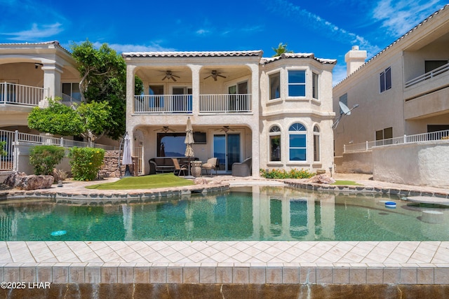1351 London Bridge Rd Unit 2, Lake Havasu City, AZ 86404 - rear view of property featuring ceiling fan, stucco siding, a fenced in pool, a balcony, and a patio