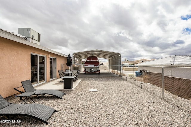 view of yard featuring a carport and fence