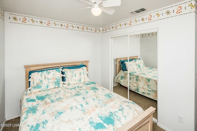 bedroom with visible vents, a ceiling fan, a closet, carpet, and baseboards