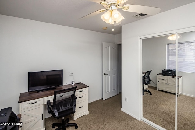 carpeted home office with visible vents, baseboards, and a ceiling fan