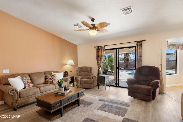 3712 Tahitian Dr, Lake Havasu City, AZ 86406 - living room with wood finished floors, ceiling fan, baseboards, and a textured ceiling