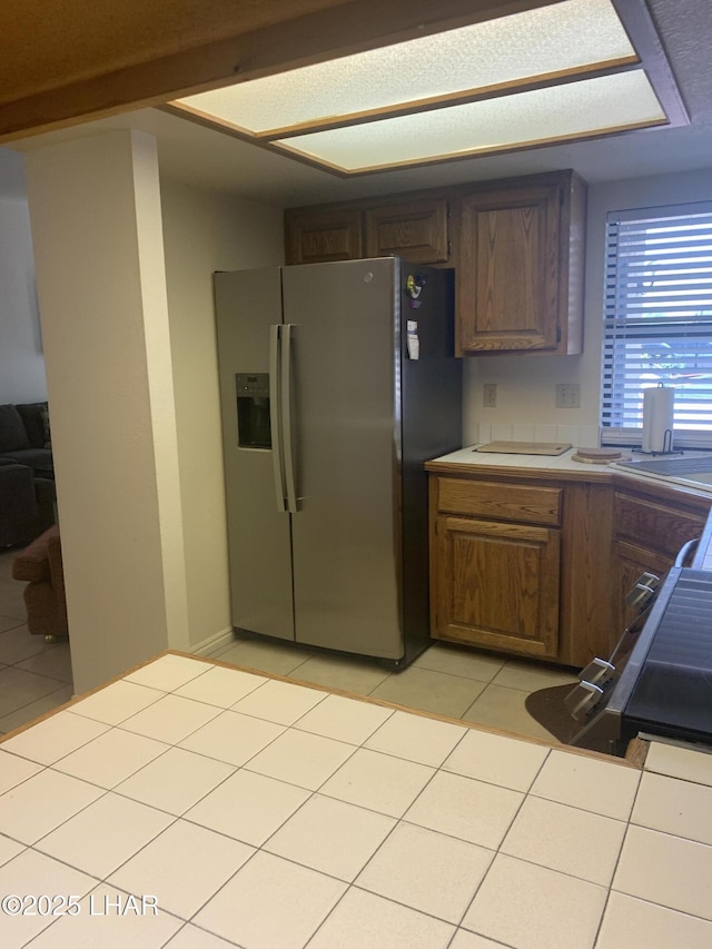 1008 Barcelona Unit 1, Lake Havasu City, AZ 86403 - kitchen with light tile patterned flooring and stainless steel refrigerator with ice dispenser