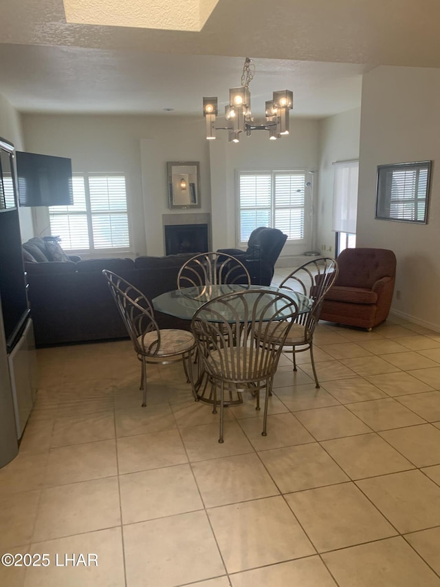 1008 Barcelona Unit 1, Lake Havasu City, AZ 86403 - dining room with an inviting chandelier, light tile patterned floors, a fireplace, and a healthy amount of sunlight