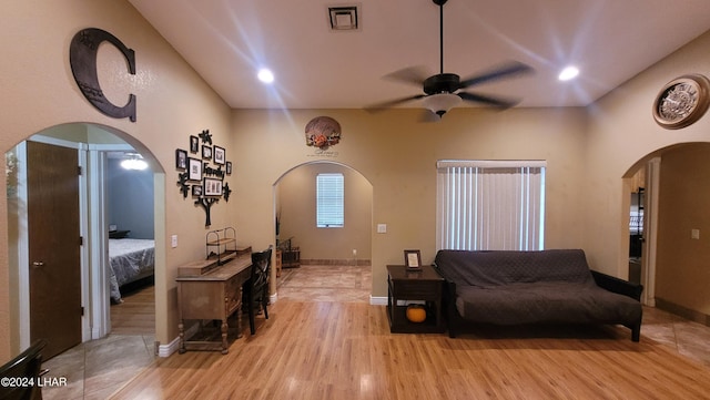 living room with ceiling fan and light hardwood / wood-style flooring