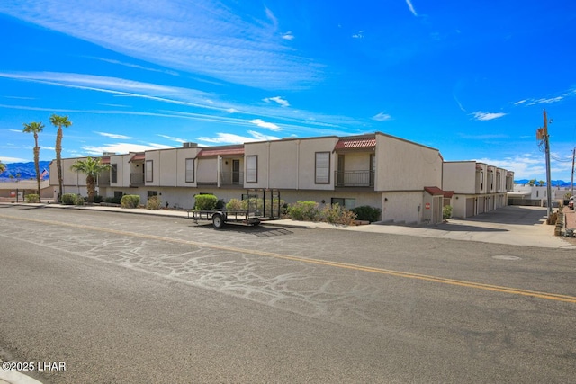 view of front of home featuring a residential view and stucco siding