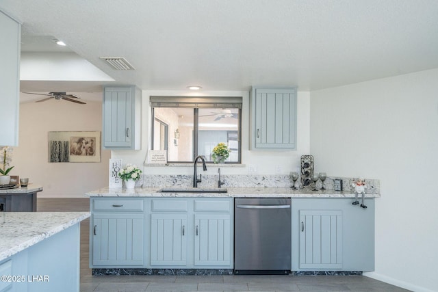 kitchen with sink, light stone countertops, dishwasher, and ceiling fan