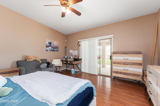 bedroom featuring lofted ceiling, access to exterior, a ceiling fan, and wood finished floors