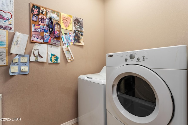 clothes washing area featuring laundry area and washing machine and clothes dryer