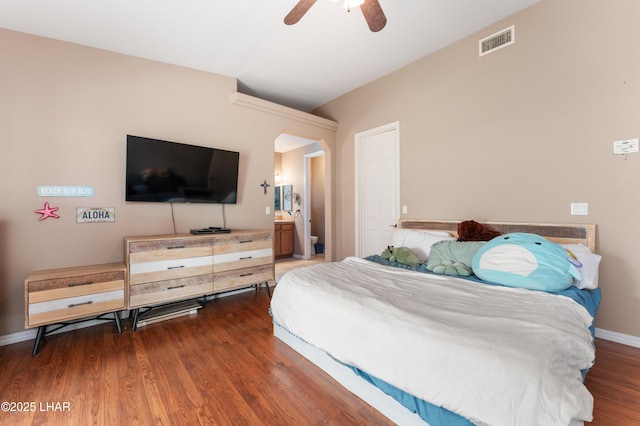 bedroom featuring baseboards, visible vents, ceiling fan, and wood finished floors