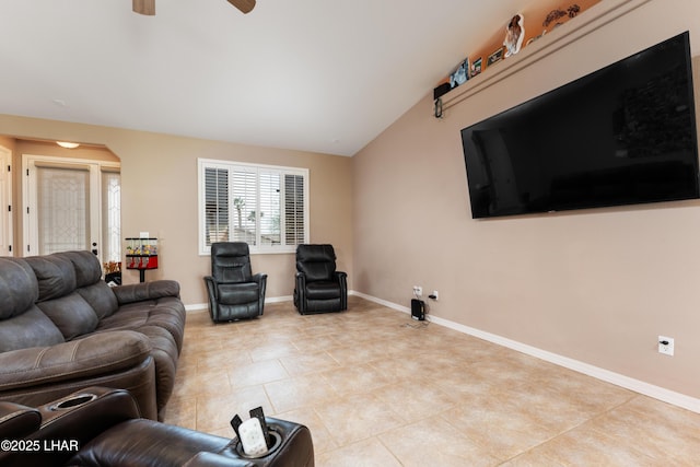 living room with vaulted ceiling, ceiling fan, light tile patterned floors, and baseboards