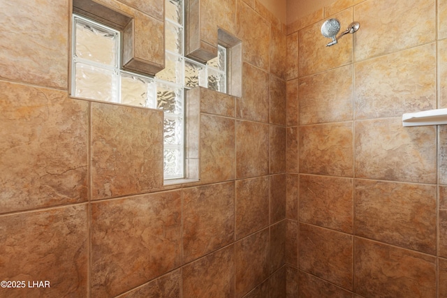 interior details with a tile shower