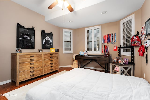 bedroom with wood finished floors, a ceiling fan, and baseboards