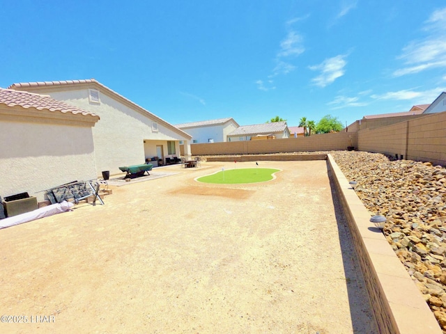2550 E Nez Perce Rd, Fort Mohave, AZ 86426 - fenced backyard featuring a putting green and a patio
