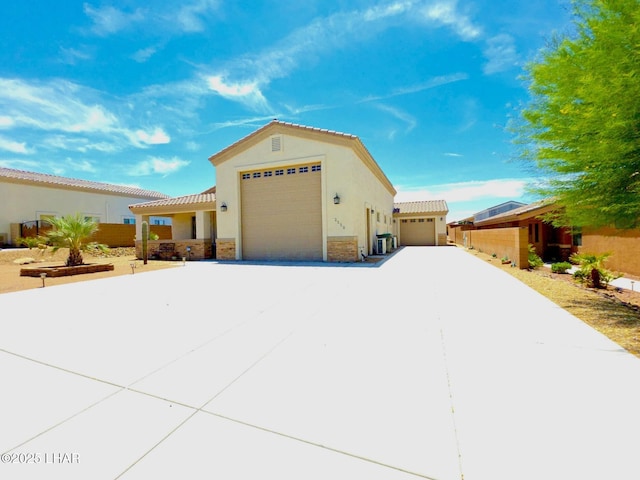2550 E Nez Perce Rd, Fort Mohave, AZ 86426 - view of front facade with stucco siding, stone siding, a garage, and a tiled roof