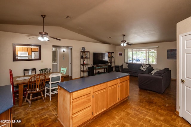 2613 Packet Ln, Lake Havasu City, AZ 86403 - kitchen with open floor plan, white microwave, dark countertops, lofted ceiling, and ceiling fan