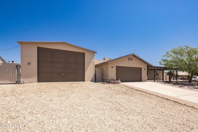 2613 Packet Ln, Lake Havasu City, AZ 86403 - view of front of house with concrete driveway, stucco siding, a gate, an attached garage, and fence