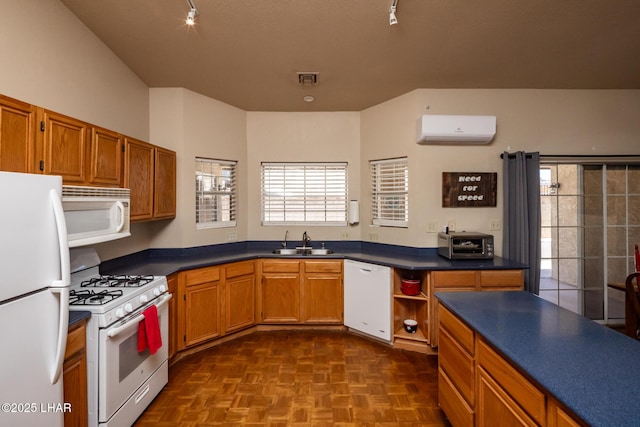 2613 Packet Ln, Lake Havasu City, AZ 86403 - kitchen featuring white appliances, a sink, dark countertops, an AC wall unit, and brown cabinets