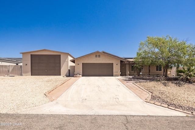 2613 Packet Ln, Lake Havasu City, AZ 86403 - ranch-style house featuring stucco siding, fence, solar panels, an attached garage, and driveway