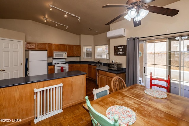 2613 Packet Ln, Lake Havasu City, AZ 86403 - kitchen featuring white appliances, a wealth of natural light, a wall unit AC, a sink, and lofted ceiling