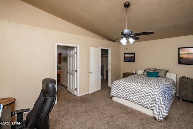 2613 Packet Ln, Lake Havasu City, AZ 86403 - carpeted bedroom featuring a walk in closet, ensuite bath, baseboards, and vaulted ceiling
