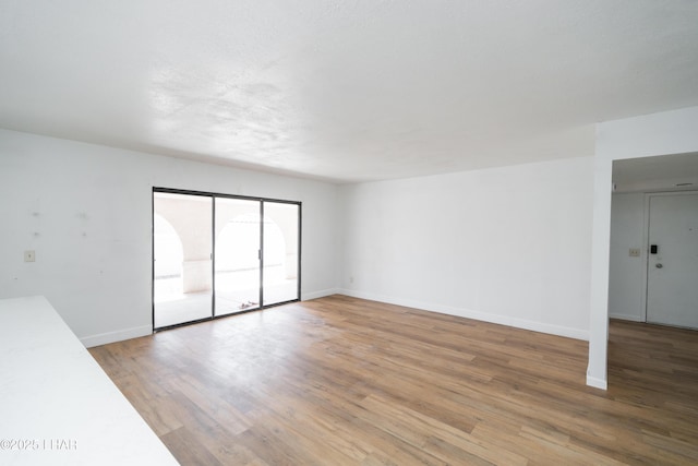 2340 Jamaica Blvd S, Lake Havasu City, AZ 86406 - unfurnished living room featuring light wood finished floors and baseboards