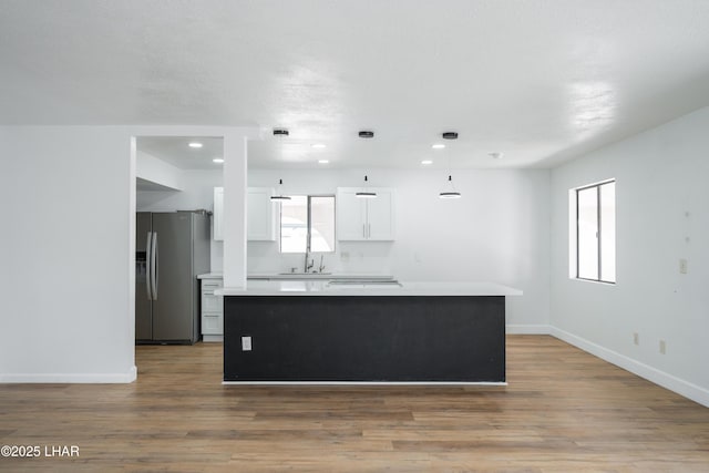 2340 Jamaica Blvd S, Lake Havasu City, AZ 86406 - kitchen with stainless steel fridge, white cabinets, light countertops, baseboards, and a center island