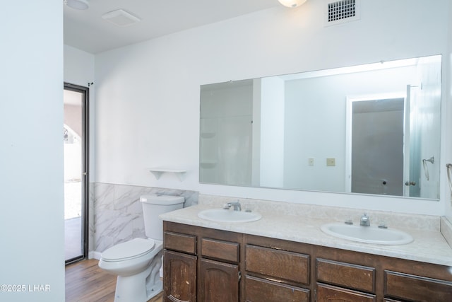2340 Jamaica Blvd S, Lake Havasu City, AZ 86406 - full bath with double vanity, toilet, tile walls, wainscoting, and wood finished floors