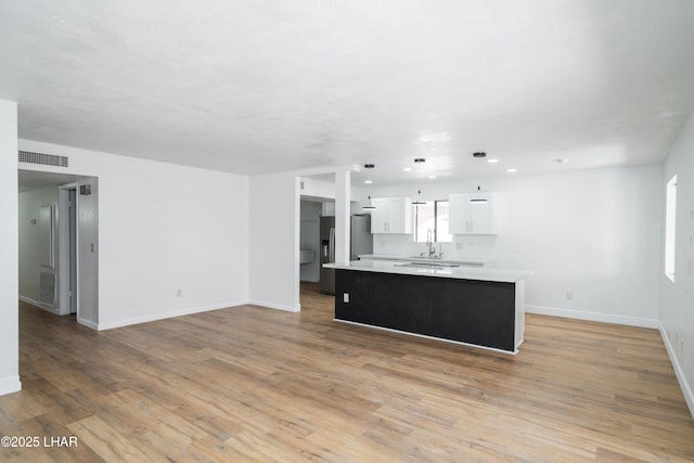 2340 Jamaica Blvd S, Lake Havasu City, AZ 86406 - unfurnished living room with baseboards, light wood-type flooring, a sink, and recessed lighting