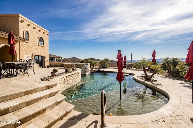 outdoor pool with a patio and outdoor dining area
