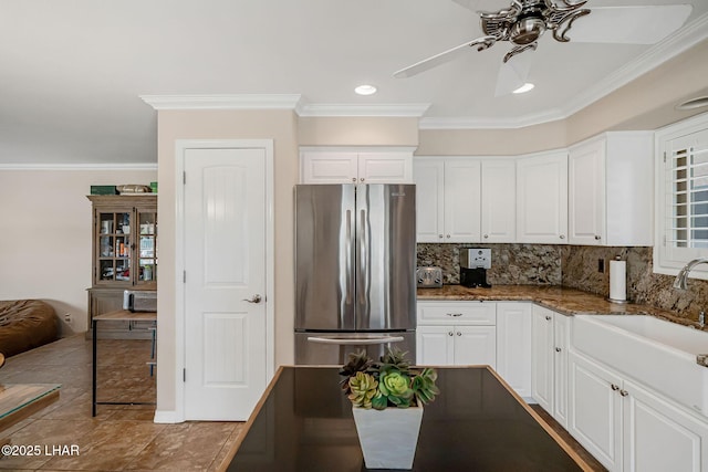 8874 Papago Loop, Parker, AZ 85344 - kitchen featuring freestanding refrigerator, crown molding, ceiling fan, backsplash, and white cabinetry