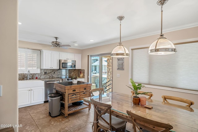 8874 Papago Loop, Parker, AZ 85344 - kitchen featuring stainless steel appliances, tasteful backsplash, white cabinetry, crown molding, and light tile patterned floors