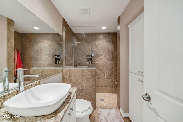 8874 Papago Loop, Parker, AZ 85344 - bathroom with vanity, a walk in shower, tile walls, and recessed lighting