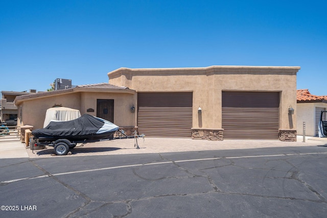 8874 Papago Loop, Parker, AZ 85344 - view of front of house featuring stucco siding, an attached garage, driveway, and a tile roof
