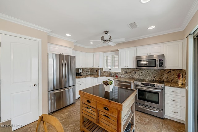 8874 Papago Loop, Parker, AZ 85344 - kitchen featuring stainless steel appliances, ceiling fan, tasteful backsplash, light tile patterned flooring, and crown molding