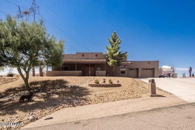 pueblo-style home with a garage